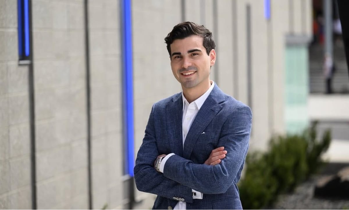Creative team gathered around a laptop reviewing work